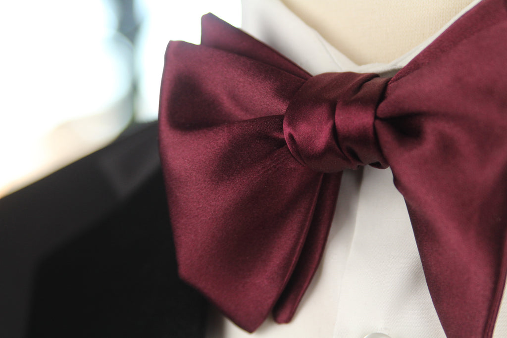 Maroon bow tie on a white background