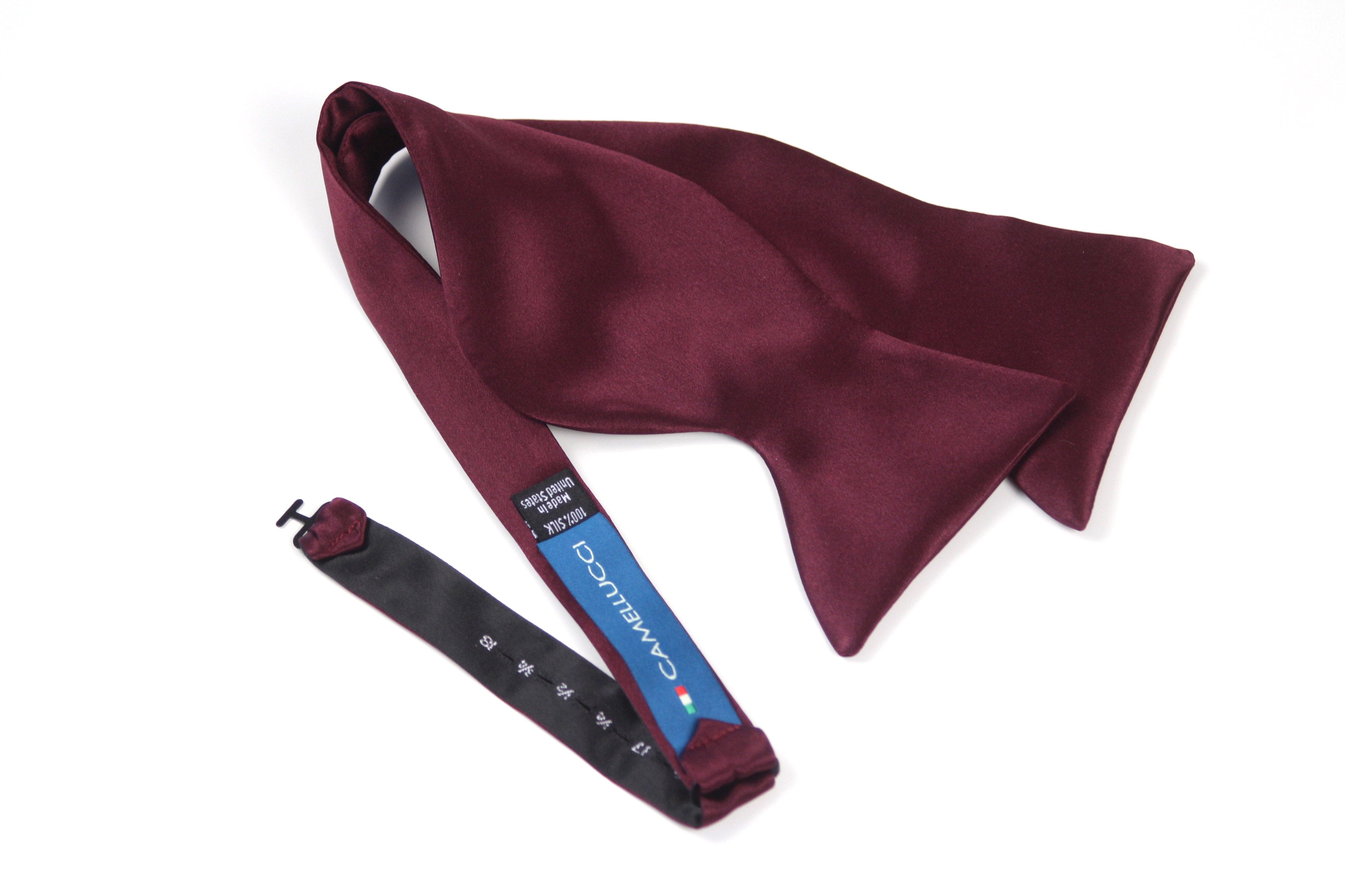 Burgundy bow tie with a matching strap on a white background