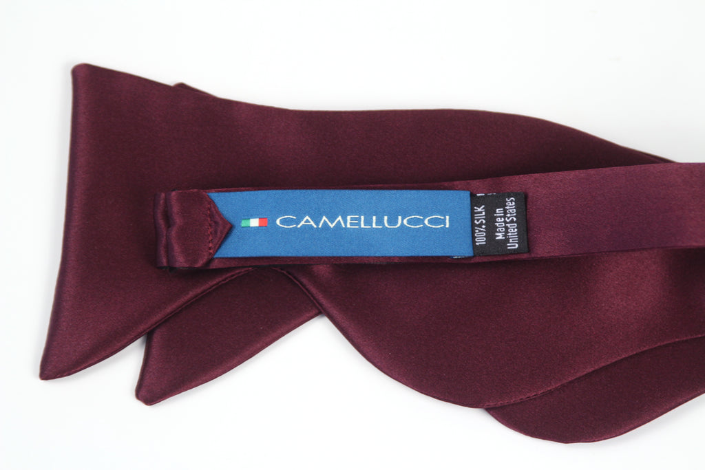 Maroon bow tie with Camellucci label on a white background