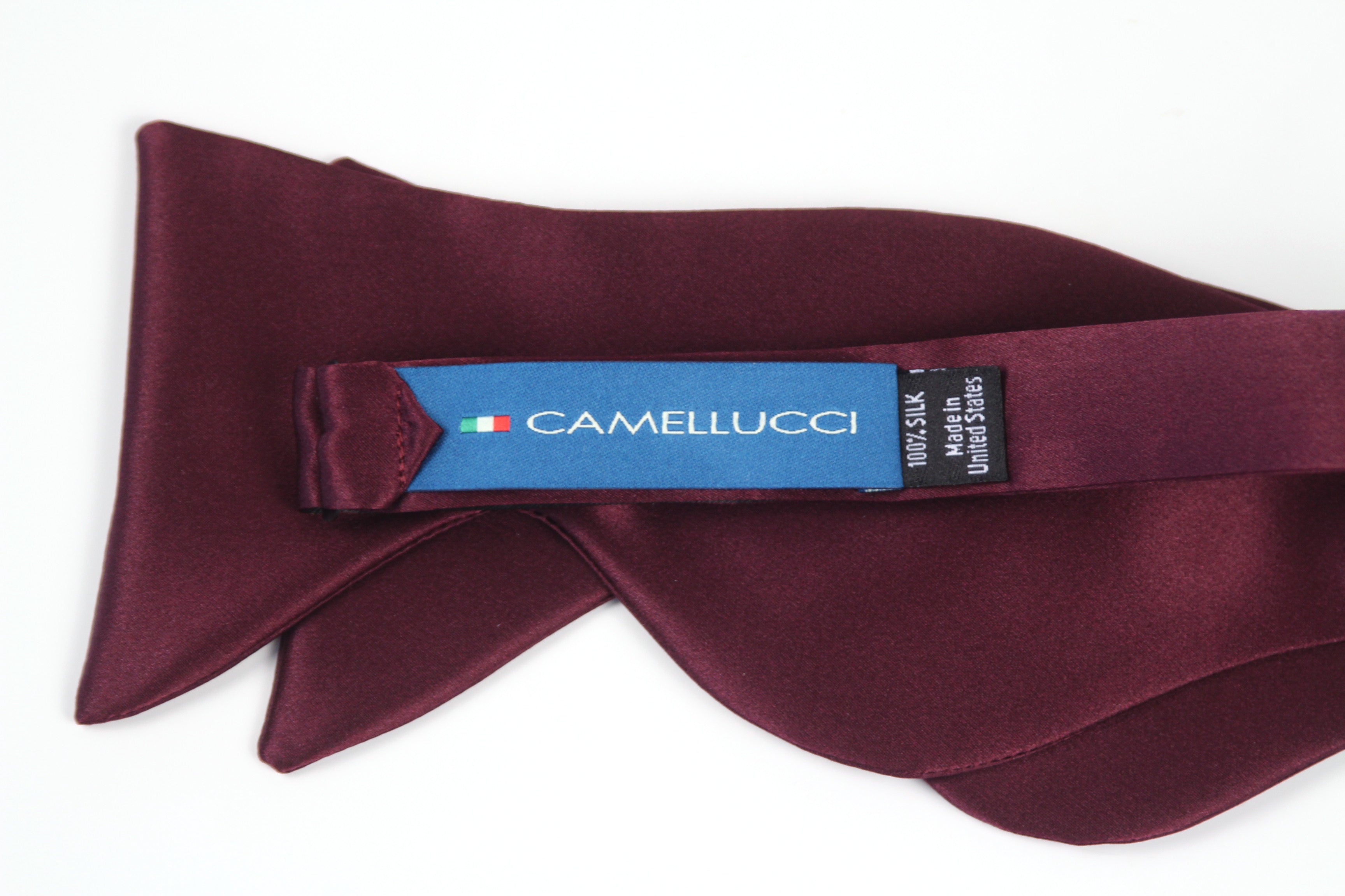 Maroon bow tie with Camellucci label on a white background