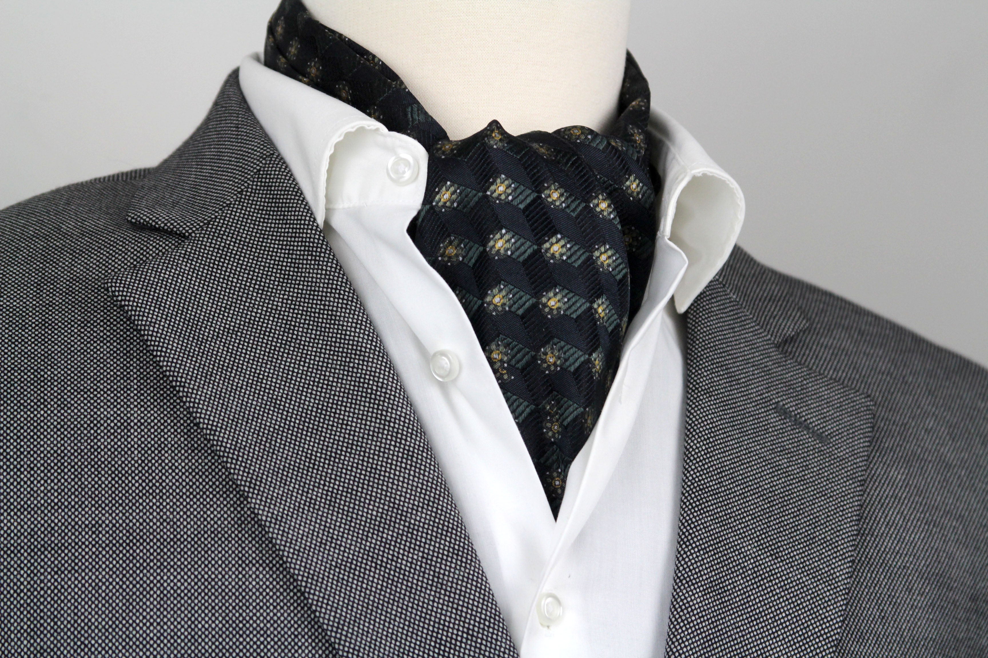 Mannequin wearing a gray suit with a white shirt and Black Mens Ascot