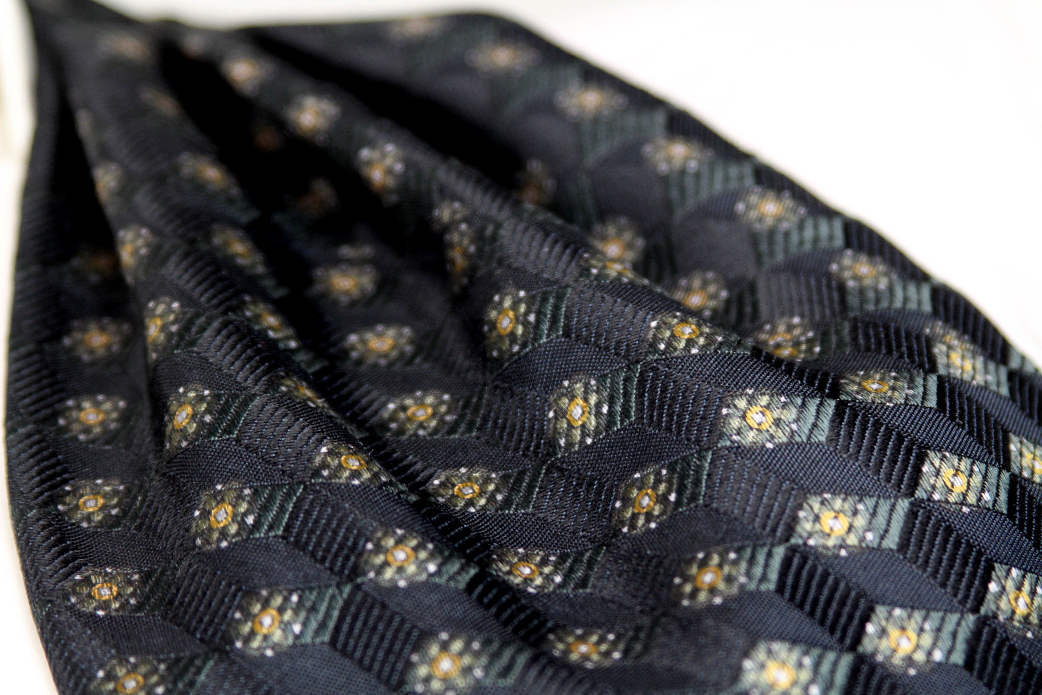 Black Mens Ascot with gold geometric pattern on a white background