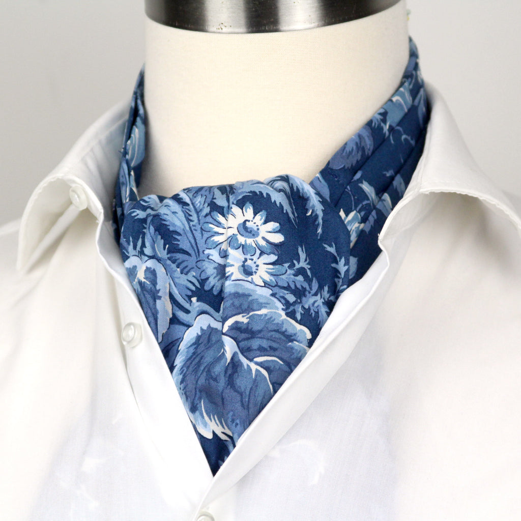 Mannequin wearing a white shirt with a blue floral patterned scarf