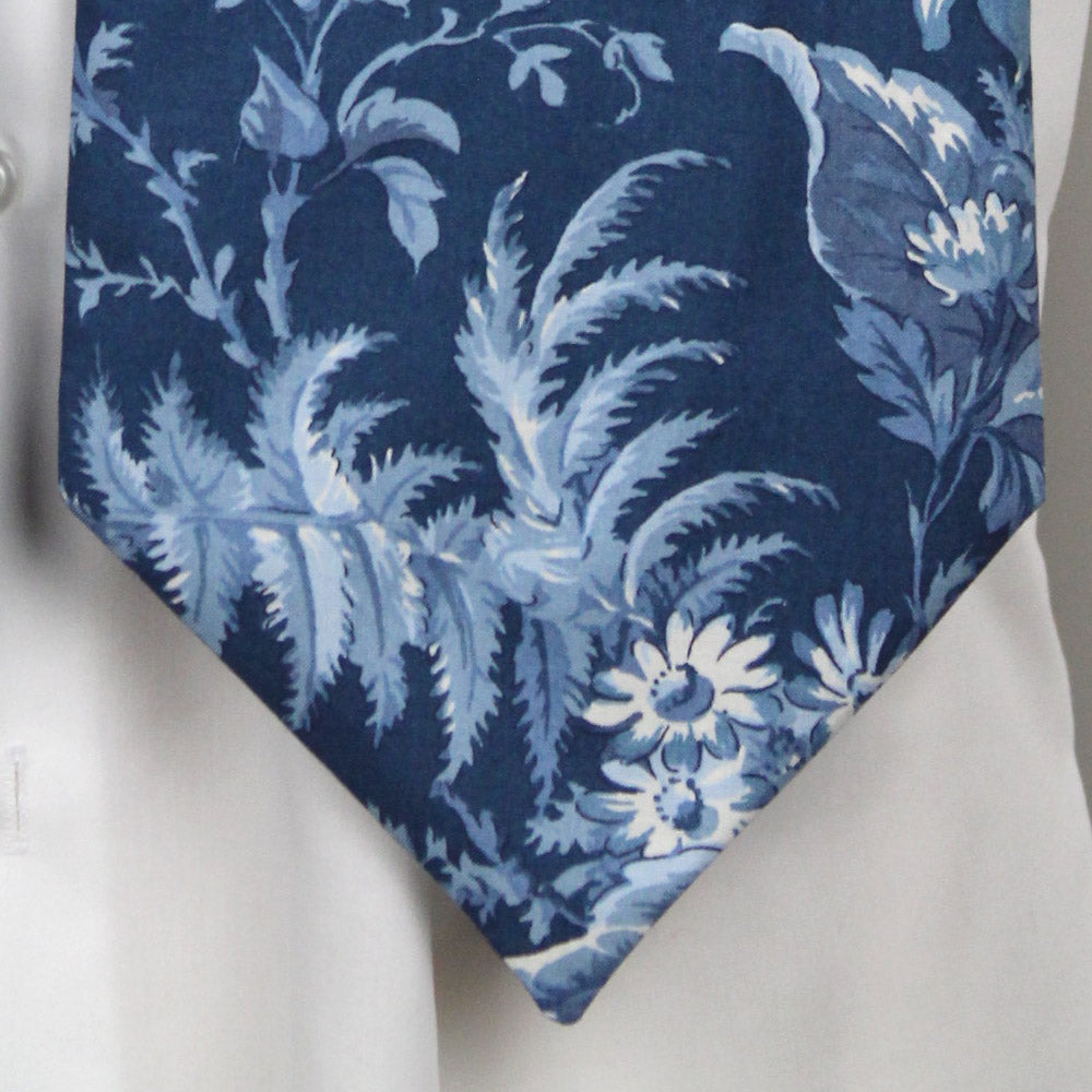 Blue floral patterned tie on a white shirt