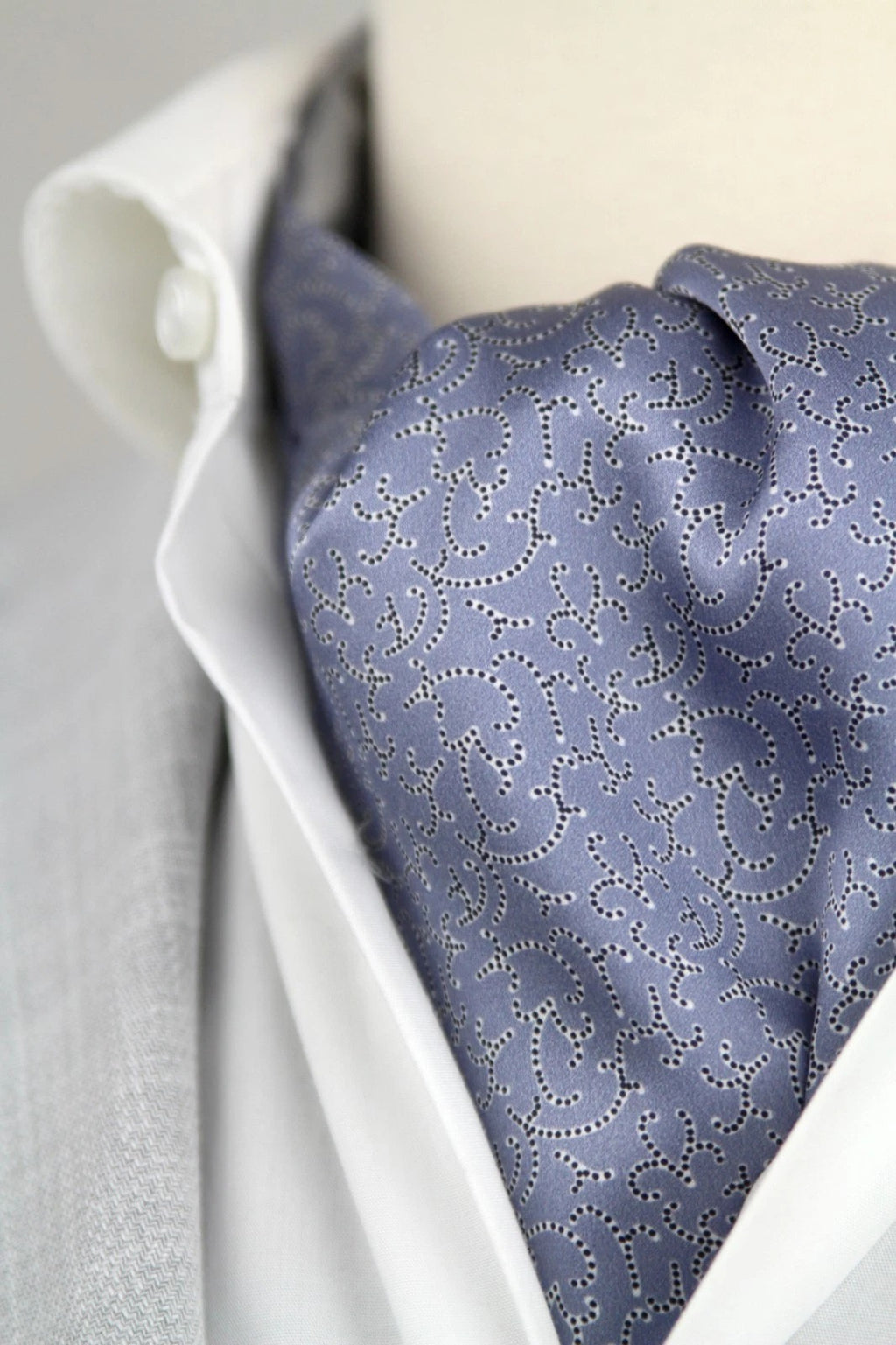 Blue patterned tie on a white shirt