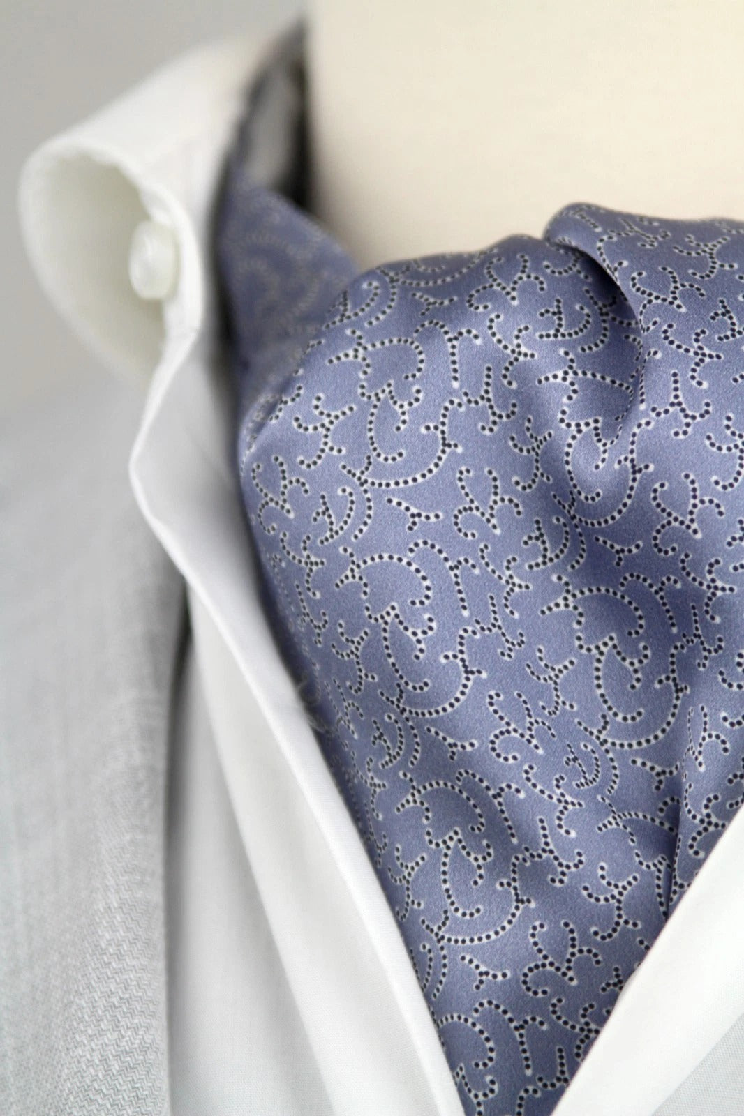 Blue patterned tie on a white shirt