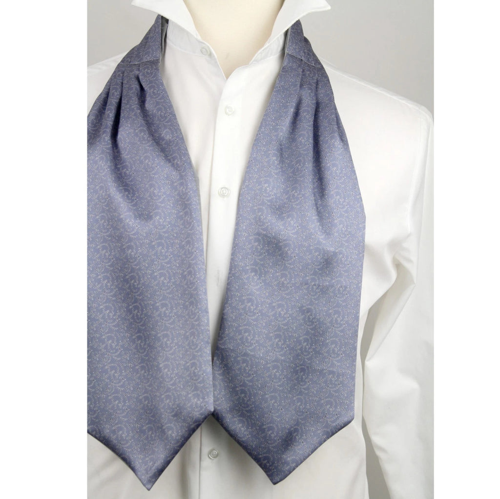 Mannequin wearing a white shirt with a blue ascot draped over the shoulders against a gray background