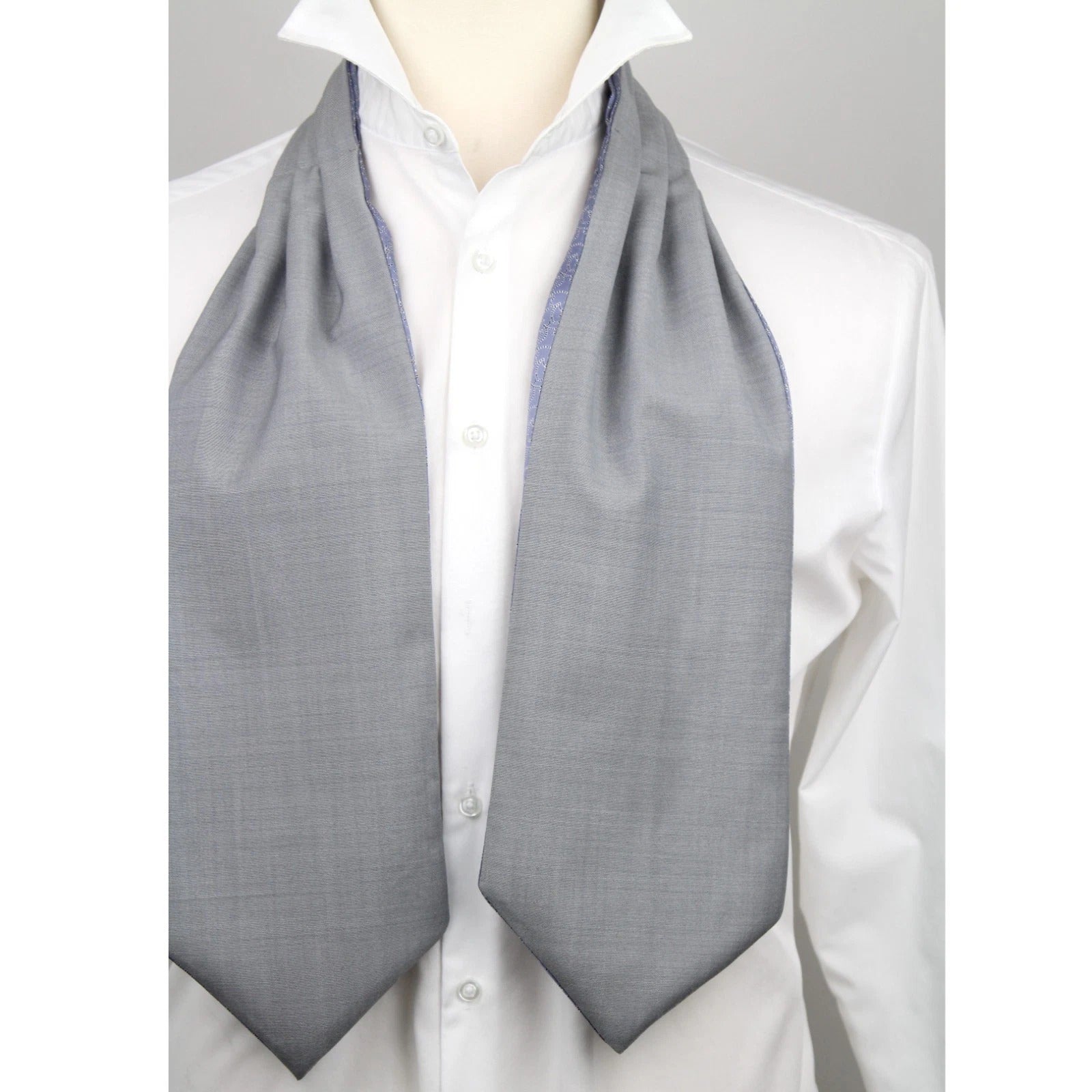 Mannequin wearing a white shirt with a gray ascot tie.
