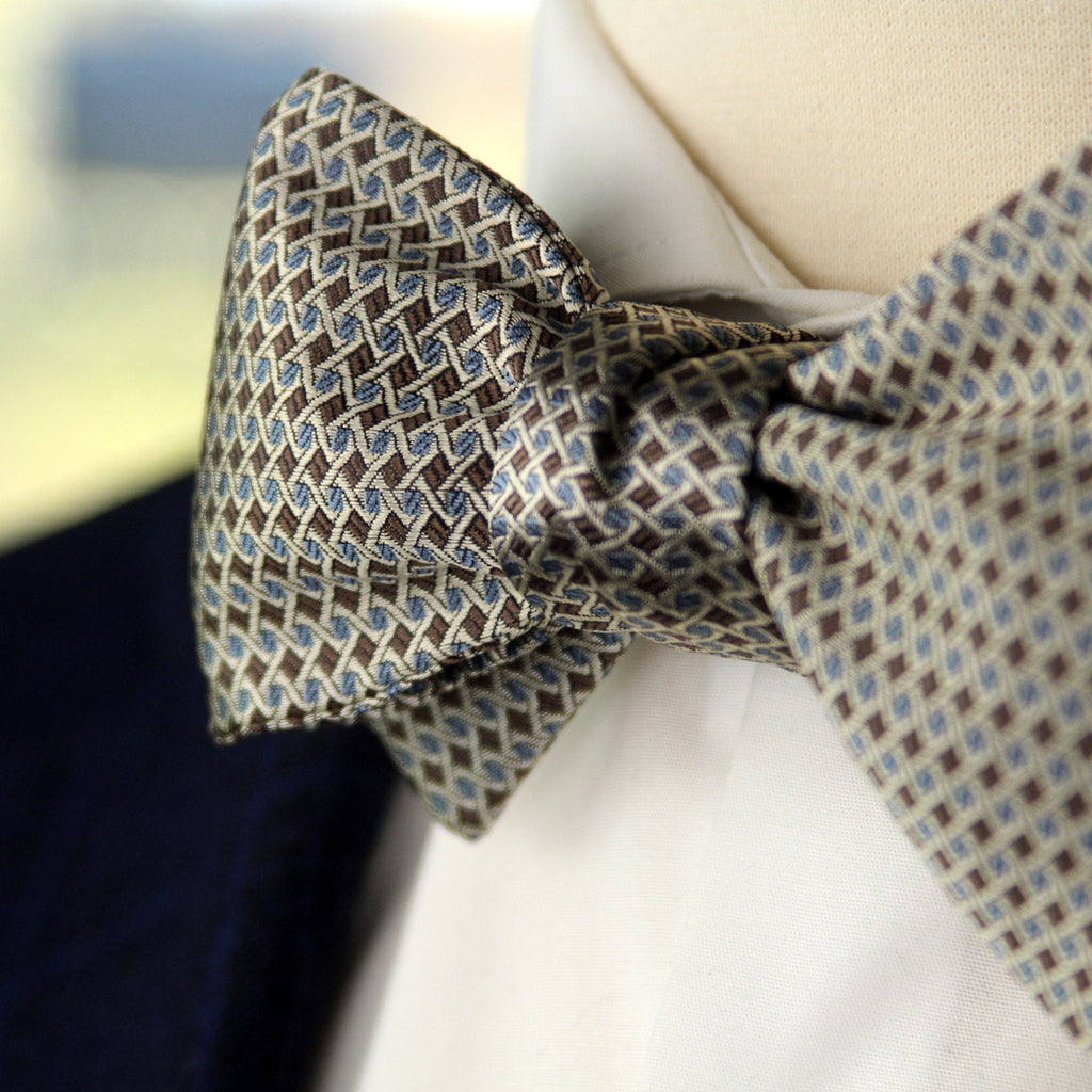 Patterned bow tie on a mannequin with a blurred background