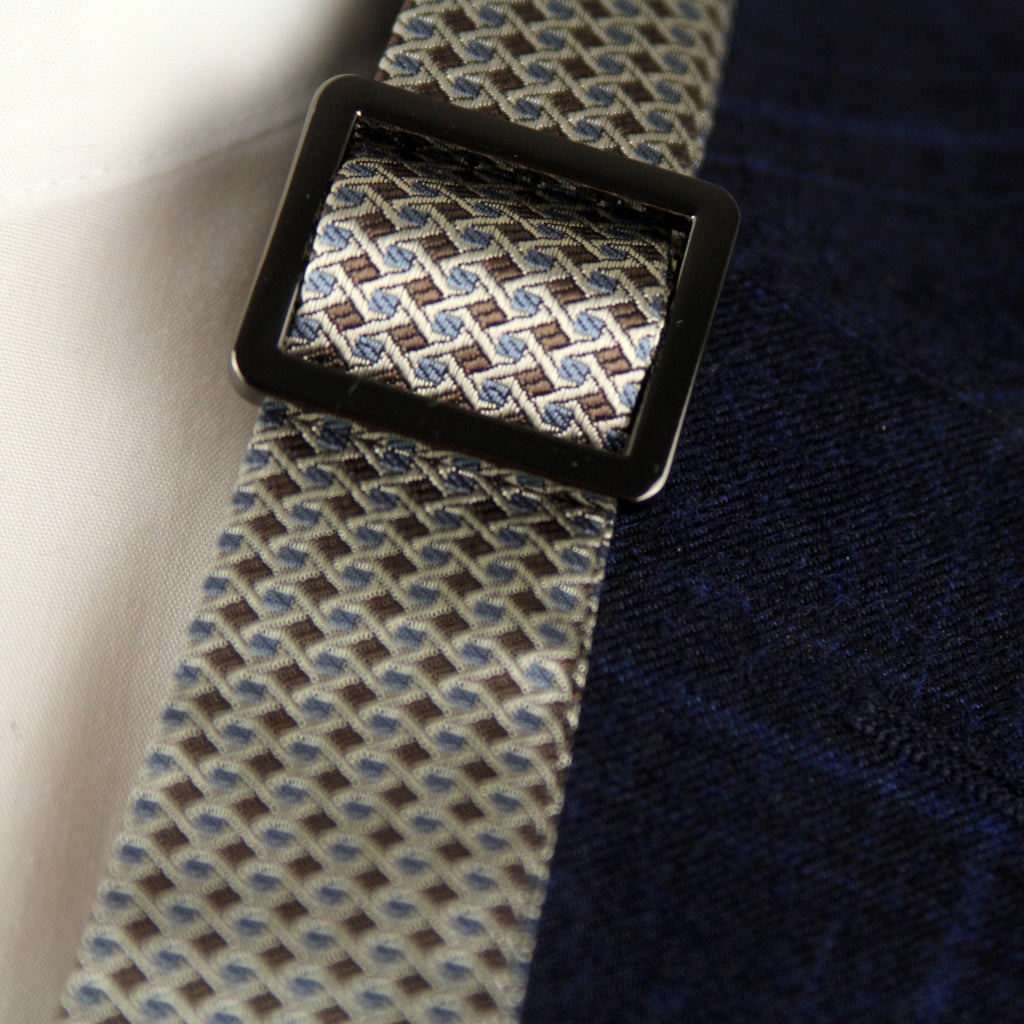 Close-up of a patterned tie with a dark blue jacket