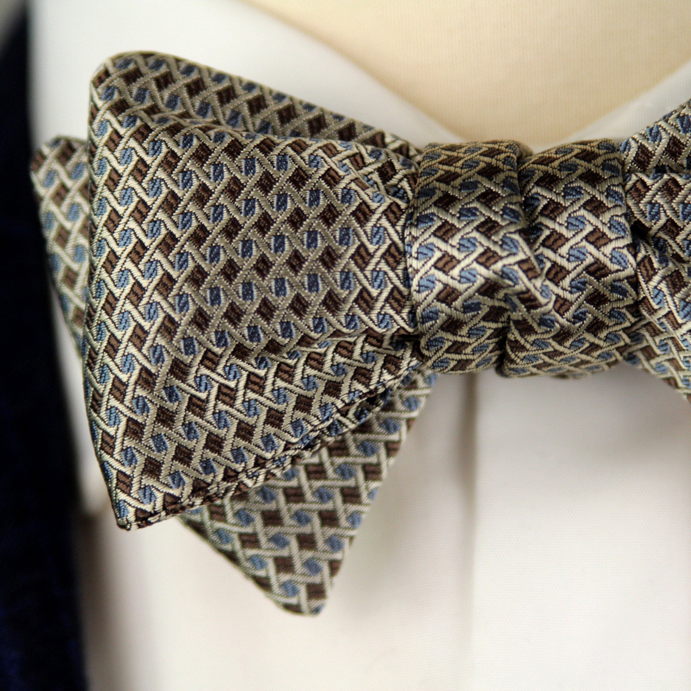 Patterned bow tie on a mannequin against a white background