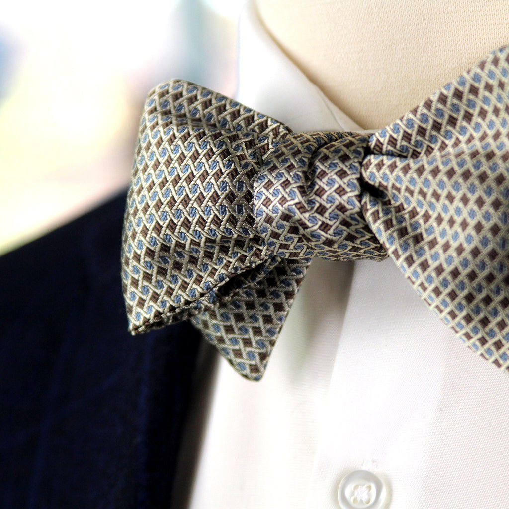 Patterned bow tie on a mannequin with a blurred background