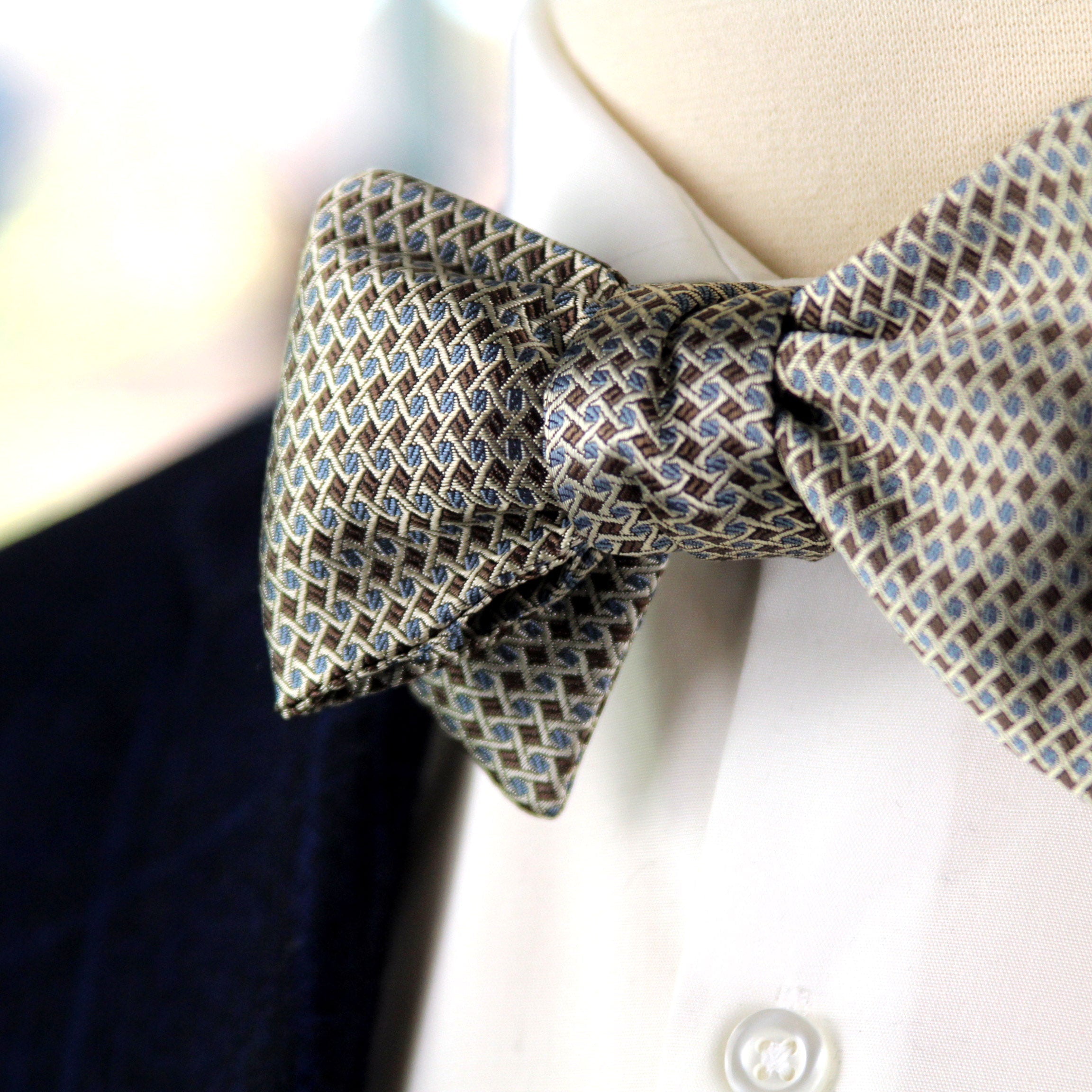 Patterned bow tie on a mannequin with a blurred background