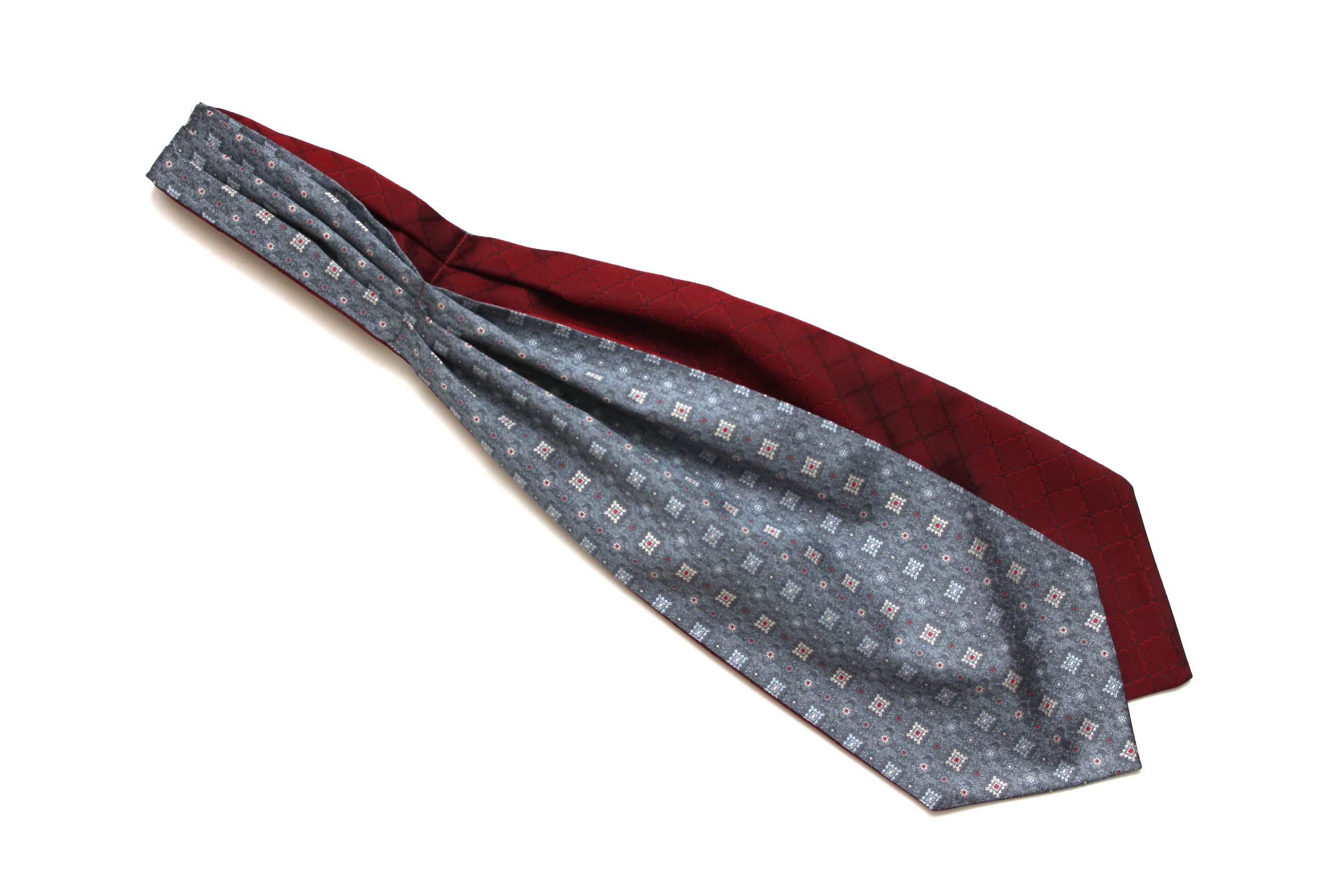 Two neckties, one with a pattern and one solid color, on a white background