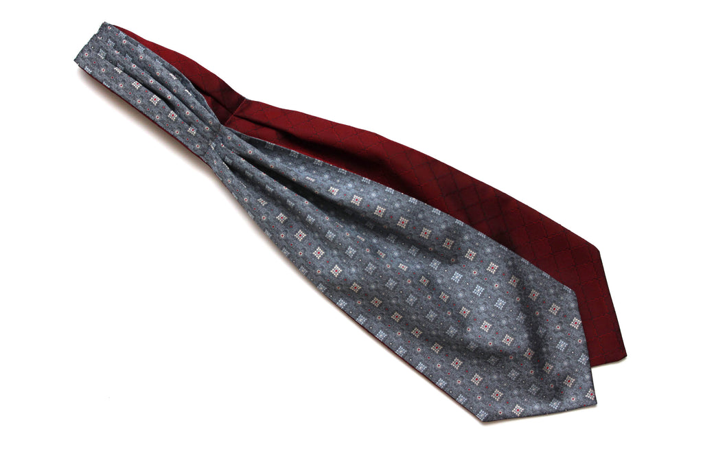 Two neckties, one gray with a pattern and the other burgundy, on a white background.