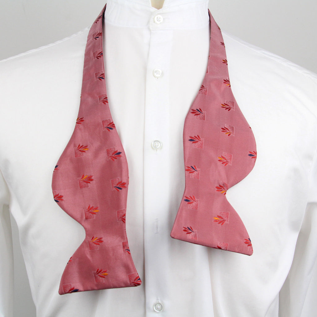 Pink bow tie with a pattern on a white shirt