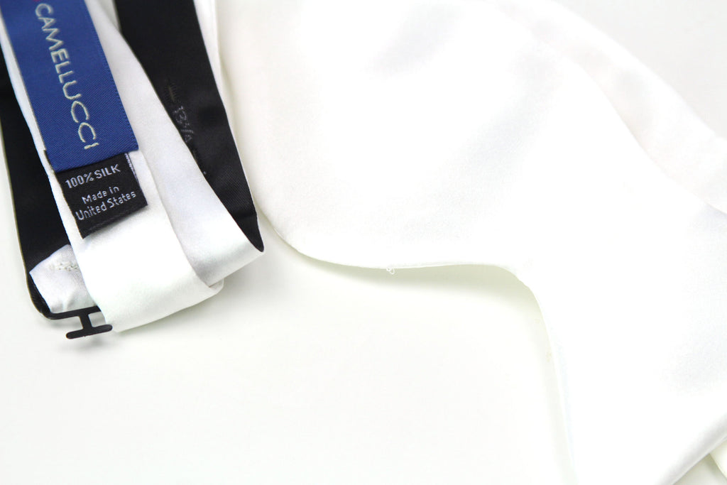 White satin ribbon with Camelucci label on a white background