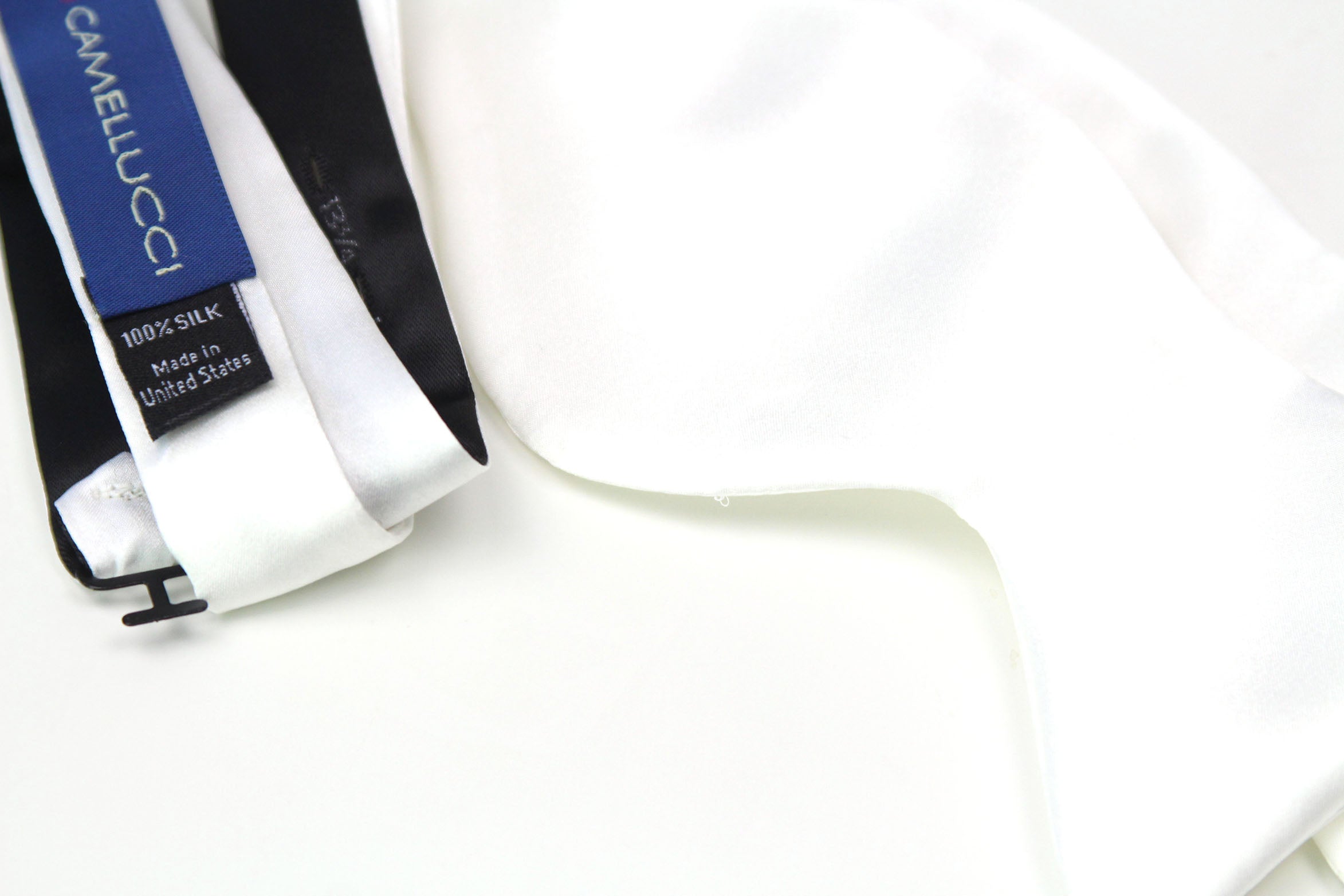 White satin ribbon with Camelucci label on a white background