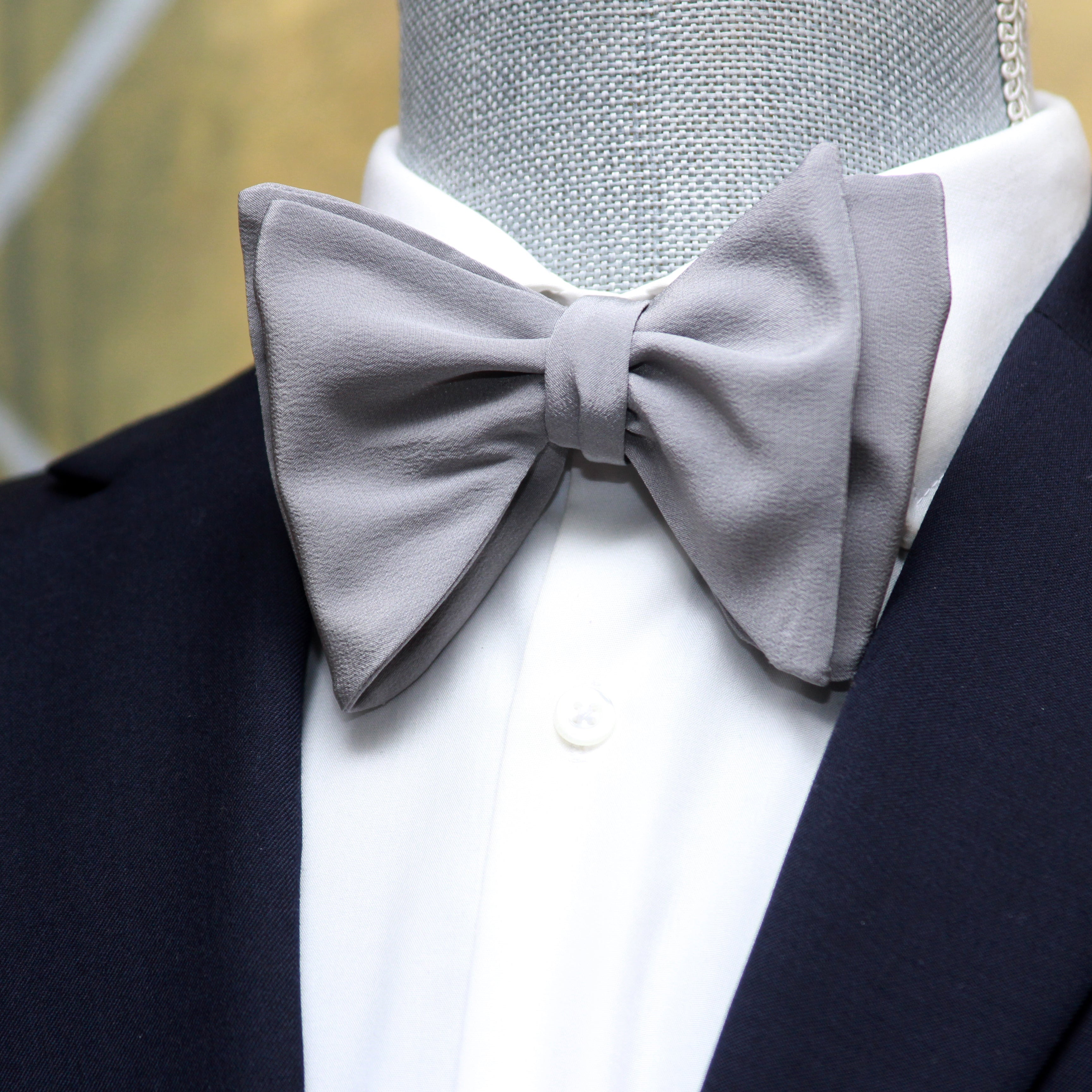 Solid Grey Silk Large Butterfly Self-Tie Bow Tie with navy jacket