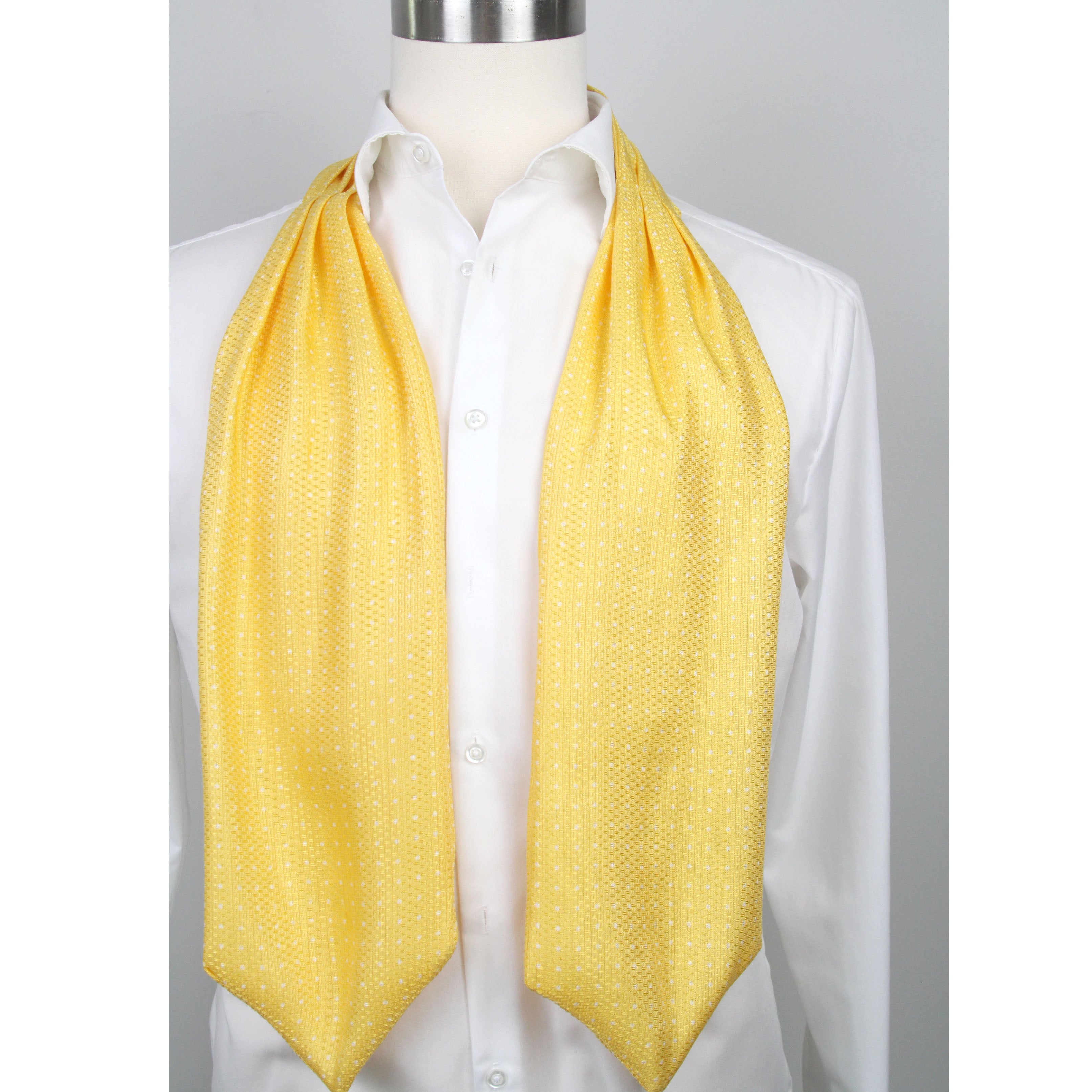 Mannequin wearing a white shirt with a yellow ascot draped over it on a gray background